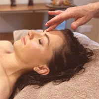 Client receiving marma point therapy at Starling Holistic
